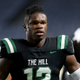 Collins Hill High School wide receiver Travis Hunter (12) watches warm-ups before the Class 7A title high school football game against Milton at Georgia State Center Parc Stadium, on Saturday, Dec. 11, 2021, in Atlanta.